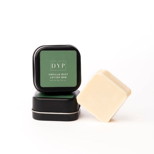 DYP vanilla mint lotion bar with a black container on a white background